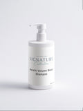 White shampoo bottle with pump labeled 'Signature Collection Sensitive Scalp Shampoo' on a light gray background