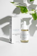 Signature Scalp Care Exfoliating Serum bottle and packaging on a light background with leaves.